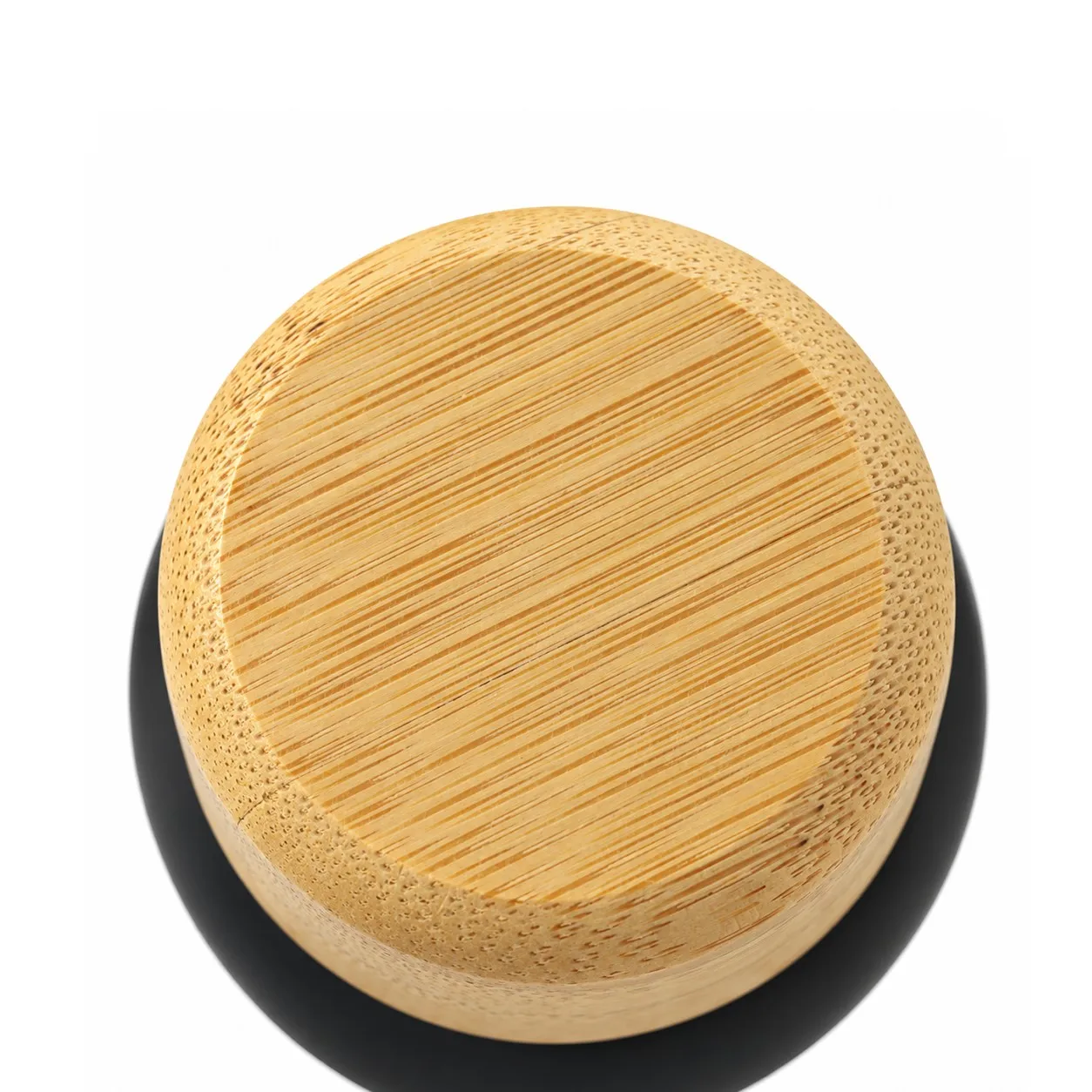 Close-up of a bamboo bottle cap showing the grain and the rim of the black steel neck