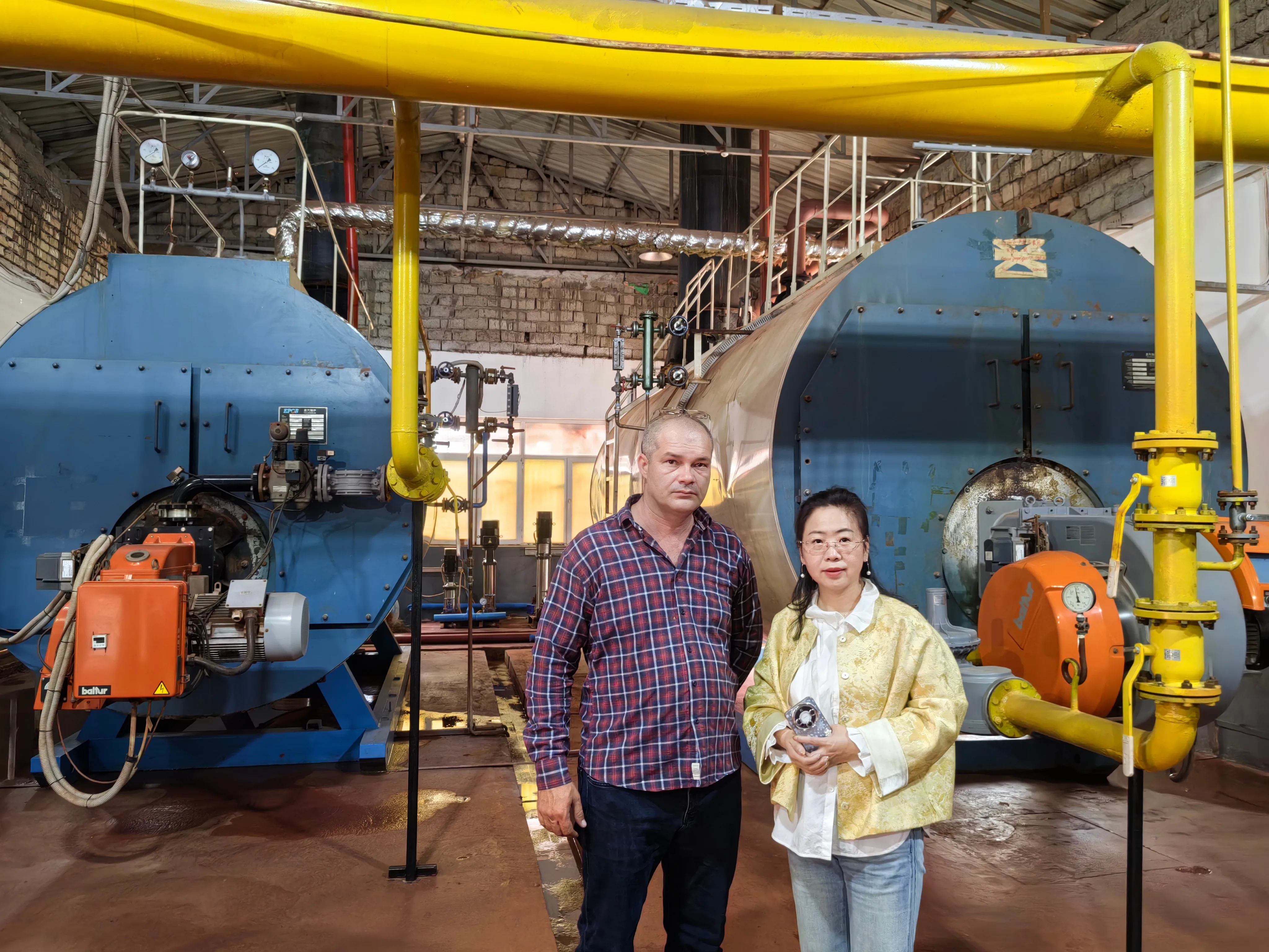 EPCB engineer and client at Uzbekistan boiler room after successful commissioning