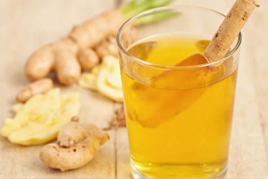 Fresh ginger and turmeric roots with golden liquid shot in glass