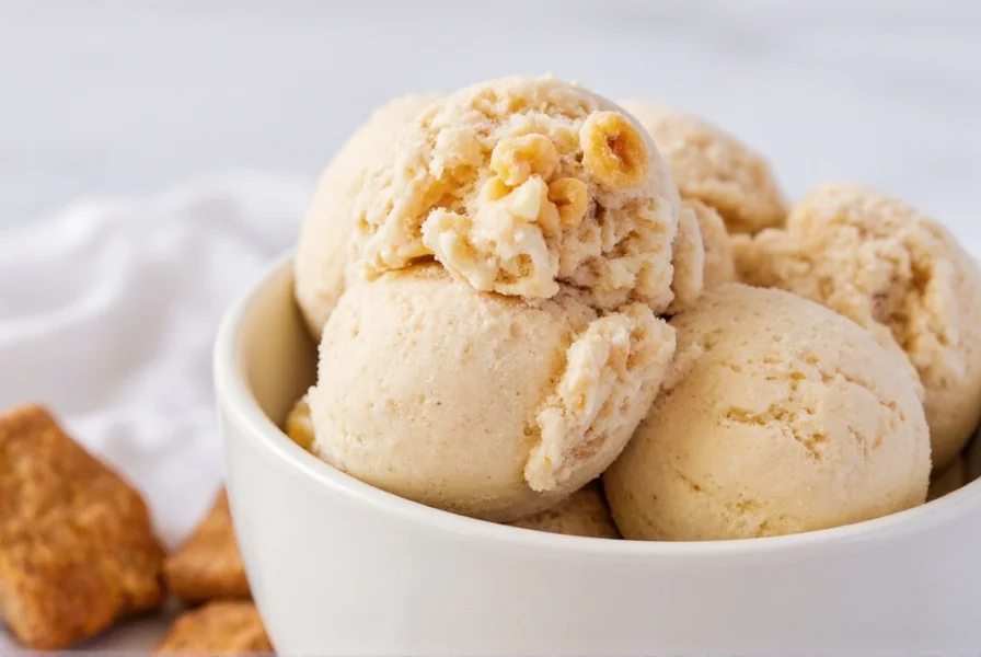 Homemade cinnamon toast crunch ice cream in a bowl with cereal pieces visible and cinnamon dusting