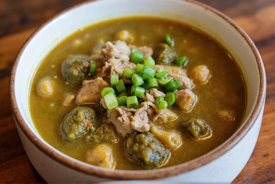 Steaming bowl of traditional hatch green chile stew with tender pork pieces and vibrant green sauce