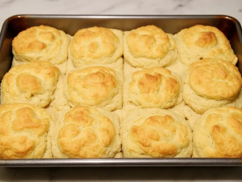 Golden homemade biscuits baked in a rectangular pan showing flaky layers