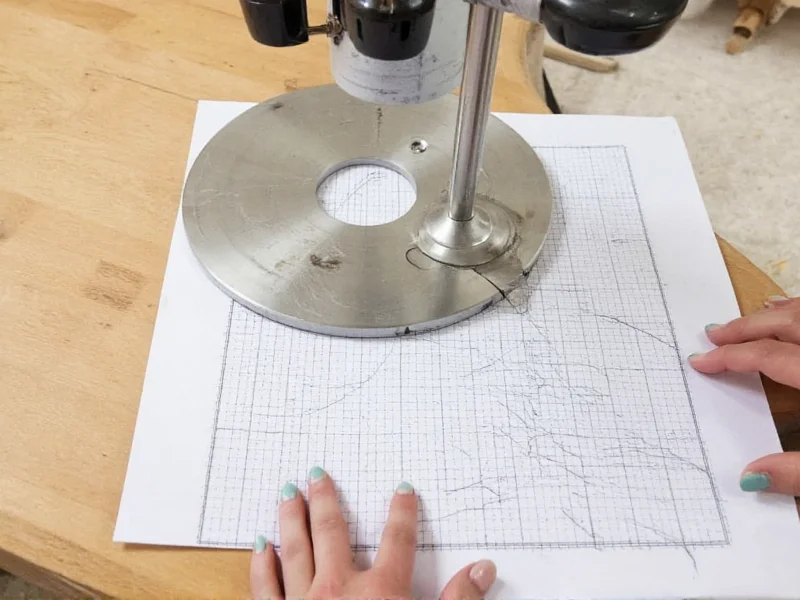 Router baseplate tracing on graph paper with measurements
