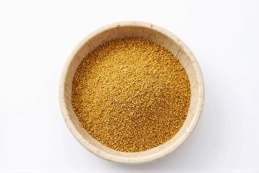 Freshly ground yellow and brown mustard seeds in mortar and pestle with whole seeds nearby