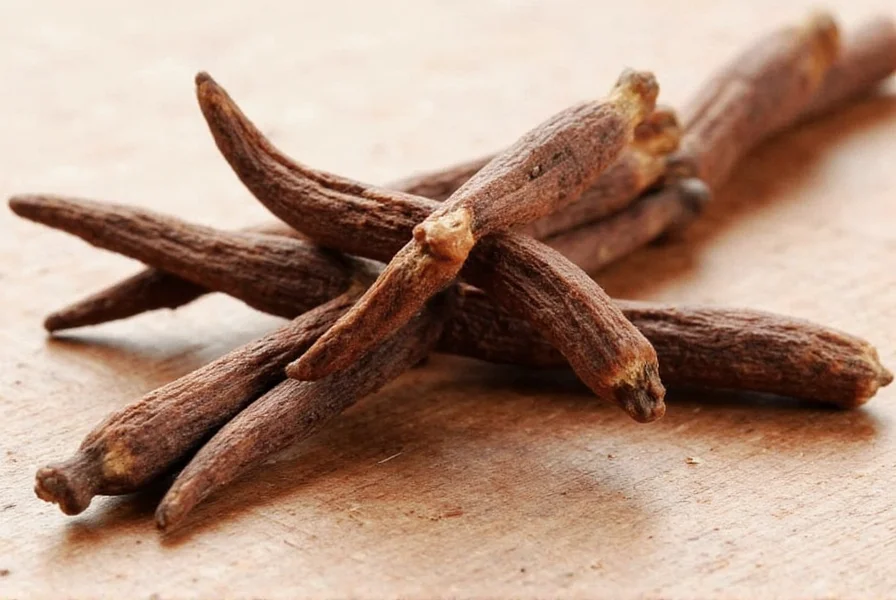 Flasche mit Nelkenöl und Tropfer auf Holzuntergrund