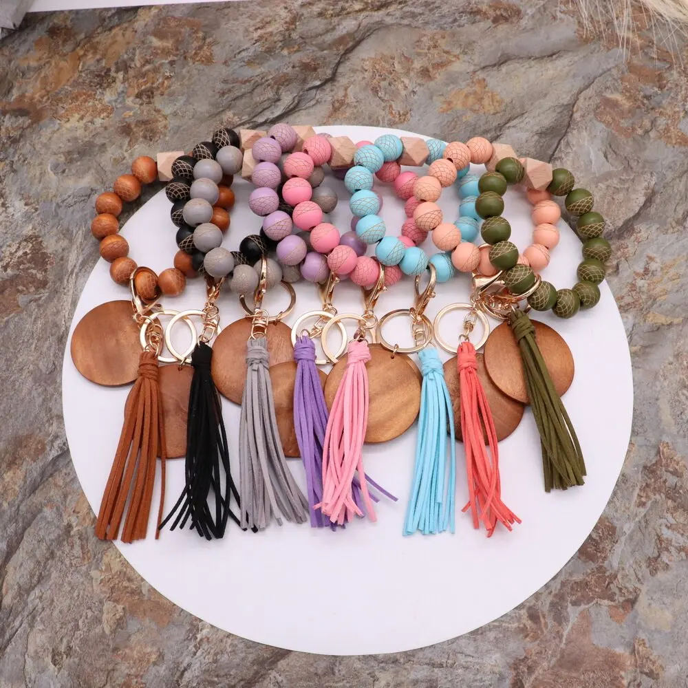 

2022 Wooden bead keychain wrist elastic cord keychain with tassel wood disc pendant for DIY laser engraving, Photo shows
