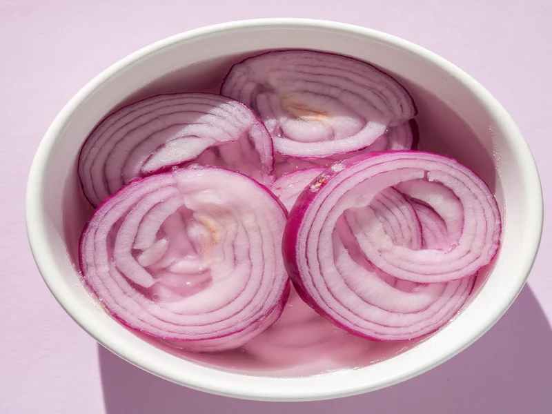 Onion slices soaking in vinegar solution