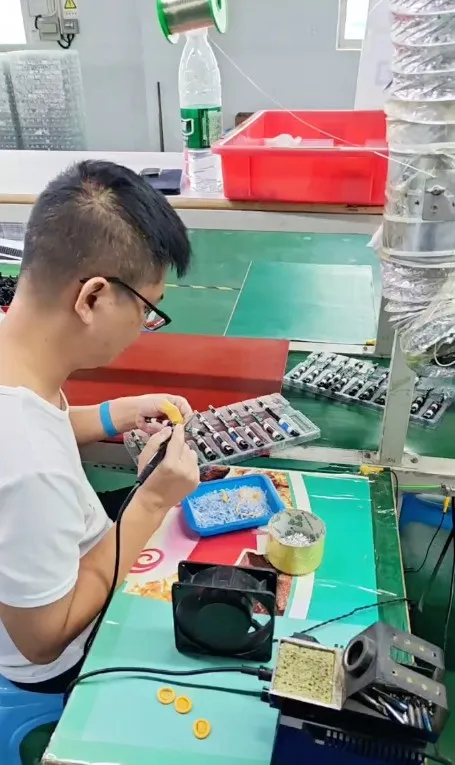 Electric toothbrush PCB and battery assembly inspection at Chinese factory workbench