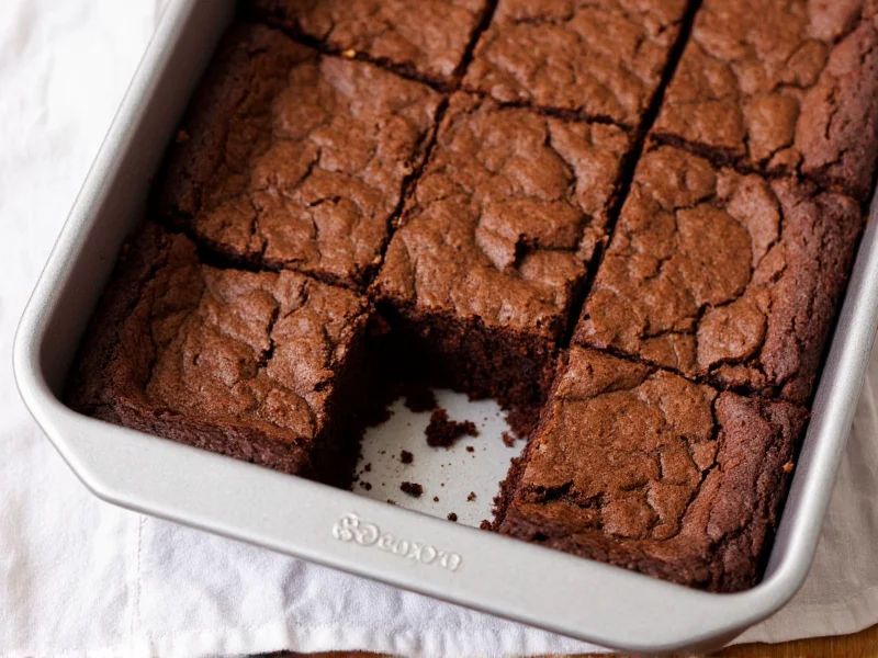 Fudgy homemade brownies with crackly top on baking pan