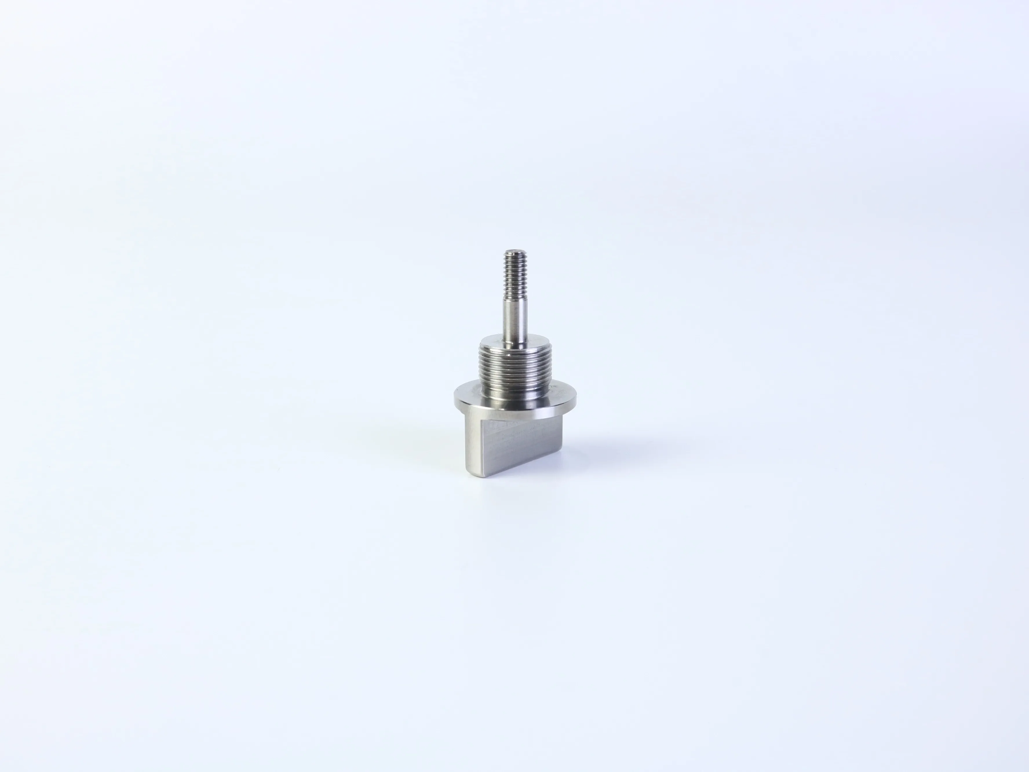 CNC turned and milled threaded metal component with a flange shoulder and rectangular mounting end
