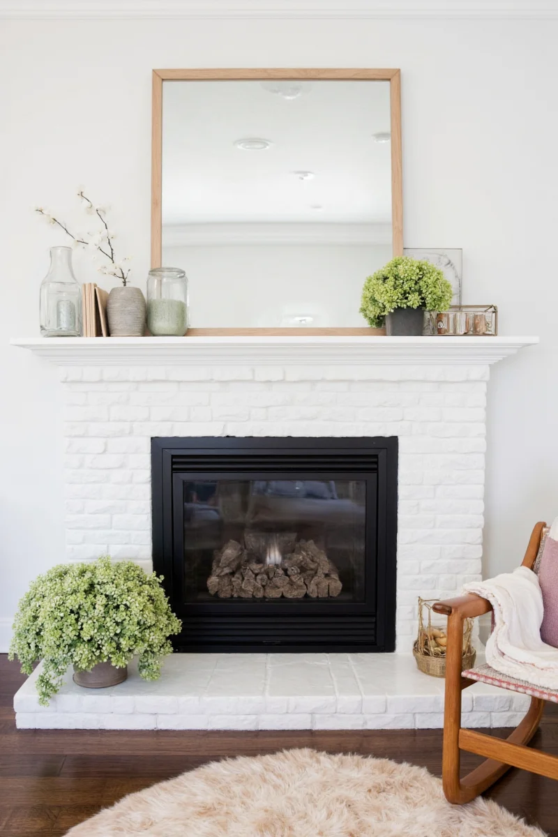 Soft pink and yellow spring decor on a wooden mantel