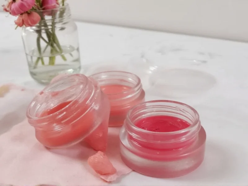Homemade lip gloss in clear containers with natural ingredients