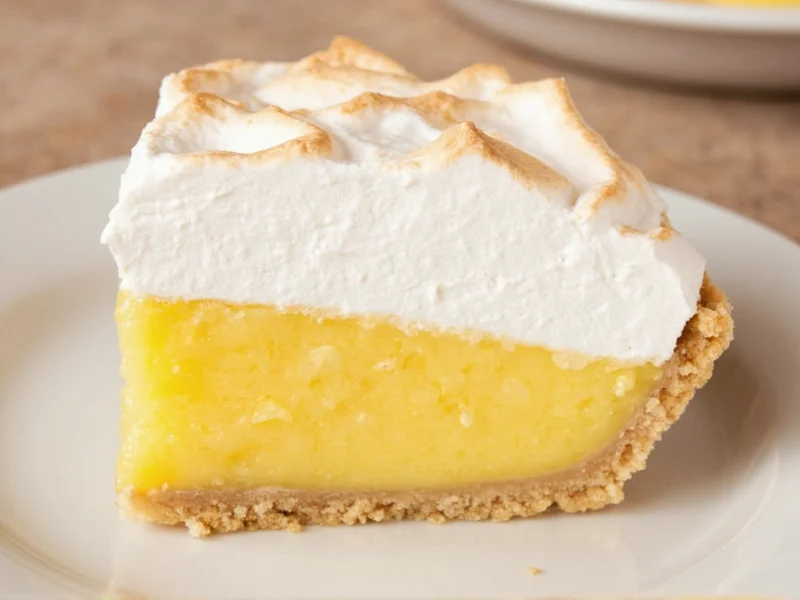Sliced homemade lemon meringue pie showing perfect layers and texture