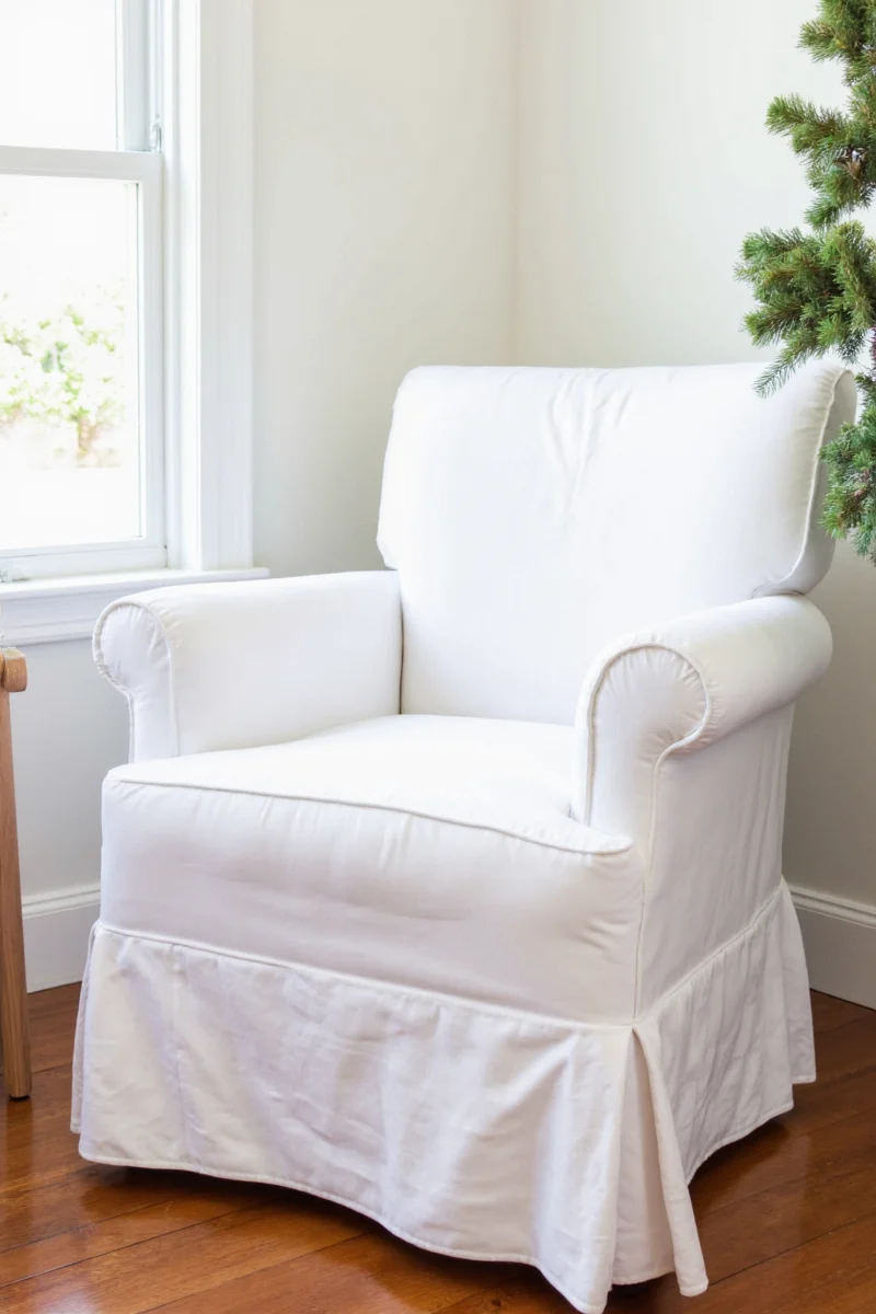 Two white slipcovers drying on a clothesline
