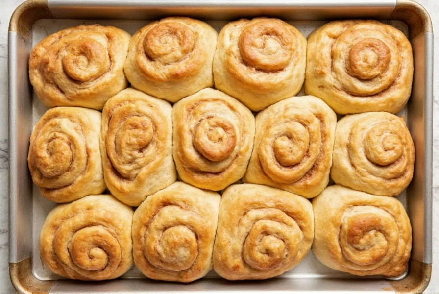 Variety of cinnamon roll focaccia variations including nutty, fruity, and spiced versions arranged on wooden baking sheet