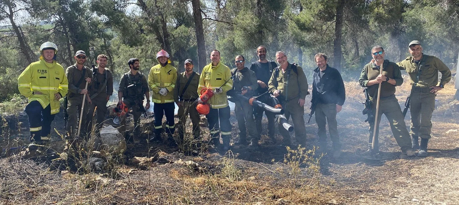 ANBEN FIRE technical team and partner ground crews after a live-fire field trial in a burned pine stand
