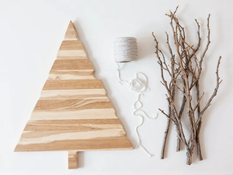 DIY wall Christmas tree materials including wood branches and string