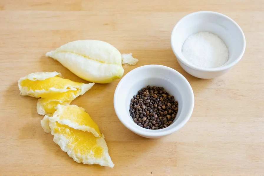 Homemade lemon pepper substitute ingredients: fresh lemon zest, black peppercorns, and salt in small bowls