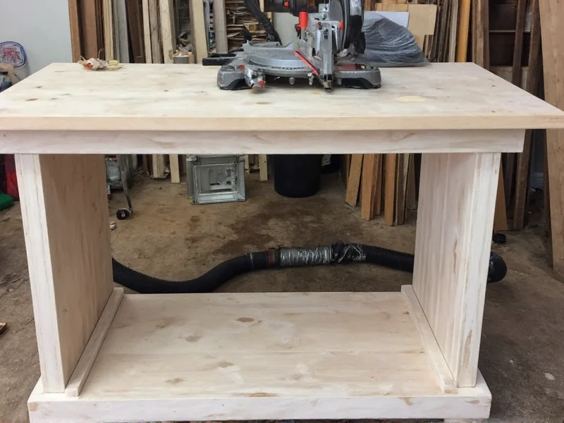 Finished DIY miter saw table with dust collection hose attached