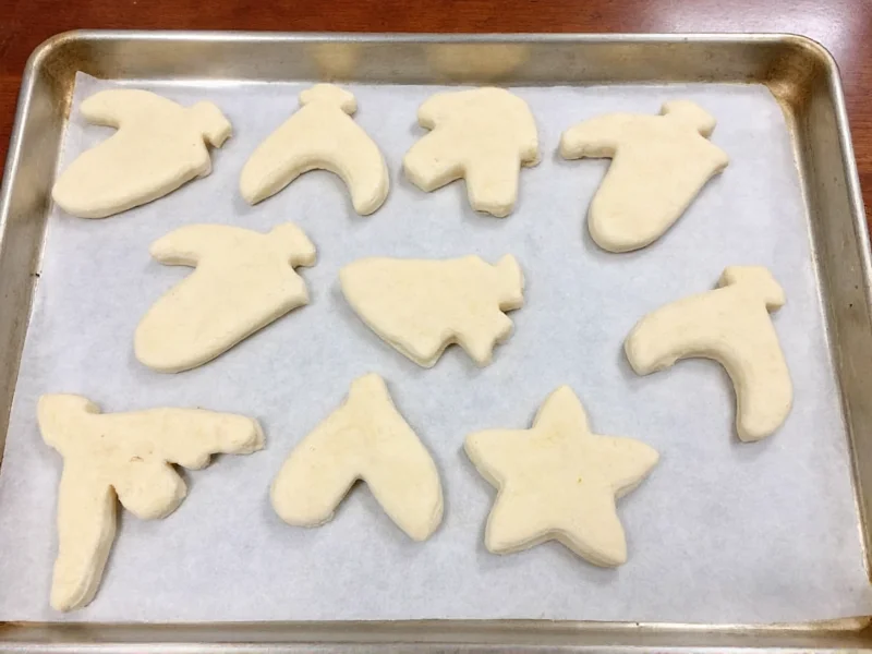 Homemade salt dough ornaments drying on parchment paper