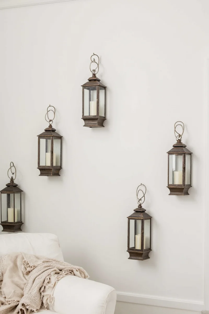 Stylish wall lanterns in a hallway with children's art
