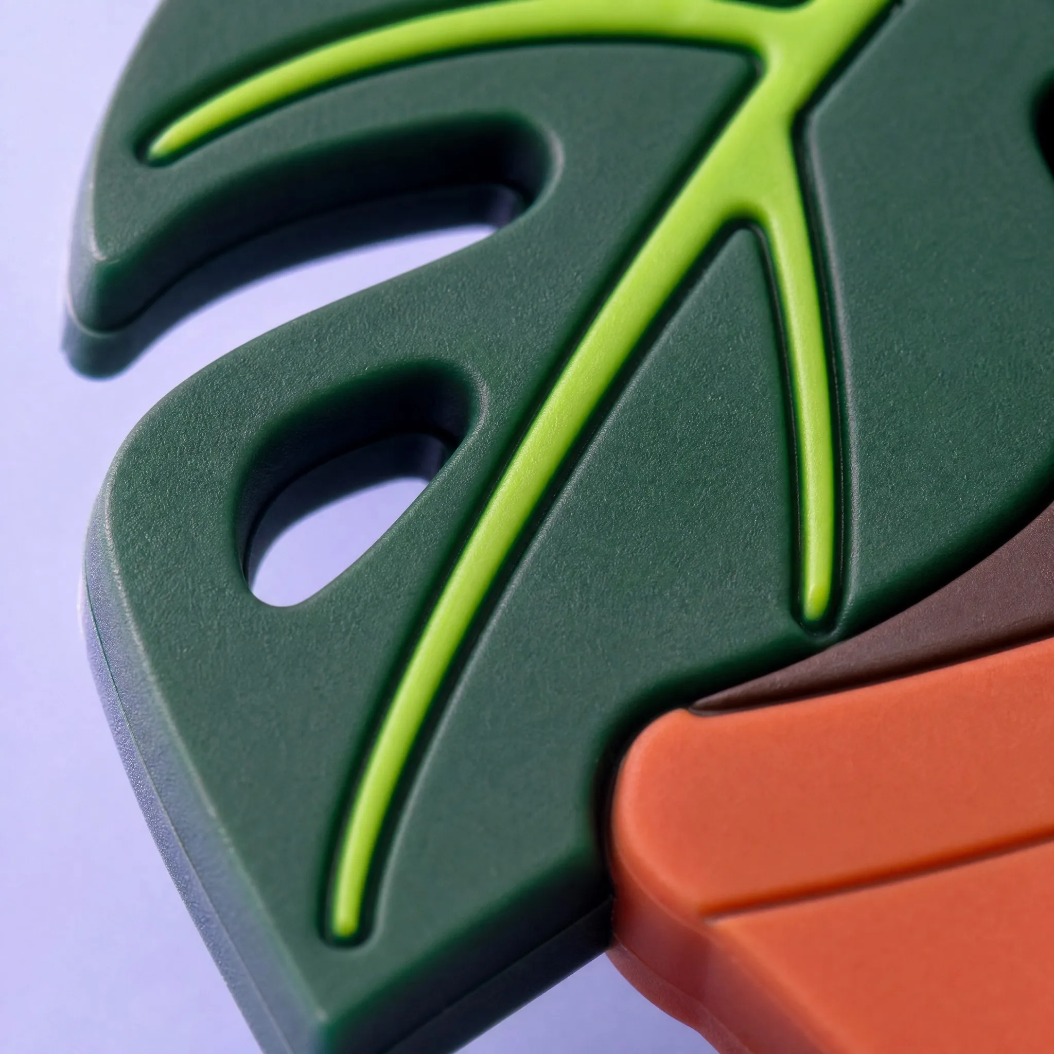 Super Macro Close-Up of 3D PVC Monstera Leaf Fenestration and Precise Color Separation Lines