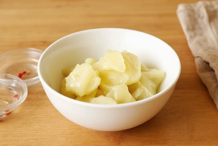 Homemade Japanese pickled ginger in glass jar with rice vinegar mixture