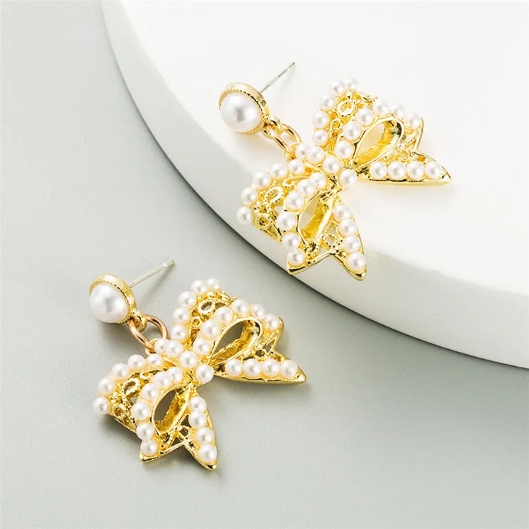 

South Korea Dongdaemun with the same exquisite bowknot pearl earrings female alloy gold-plated wild S925 silver needle earrings, Picture shows