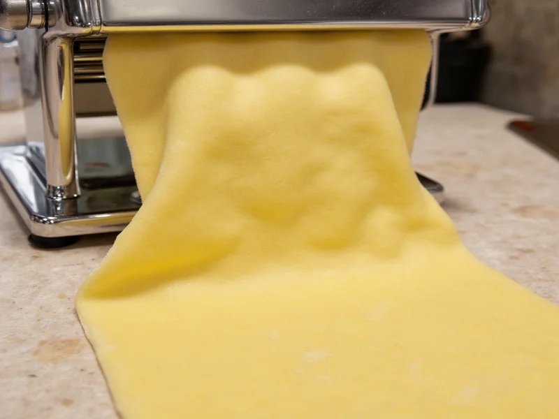 Rolled ravioli dough sheet with even thickness on pasta machine