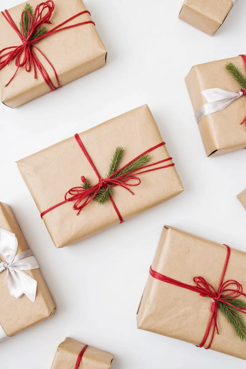 Brown wrapped gifts arranged under tree