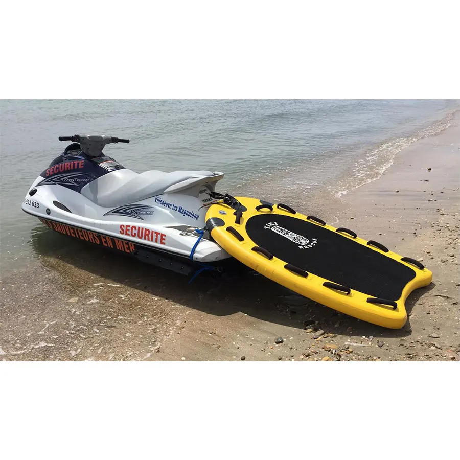 

STOCK  Yellow lifeguard drop stitch fabric inflatable life saving board rescue sled behind jet ski