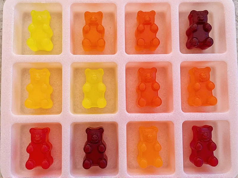 Assortment of creative homemade gummy bear flavors in different molds