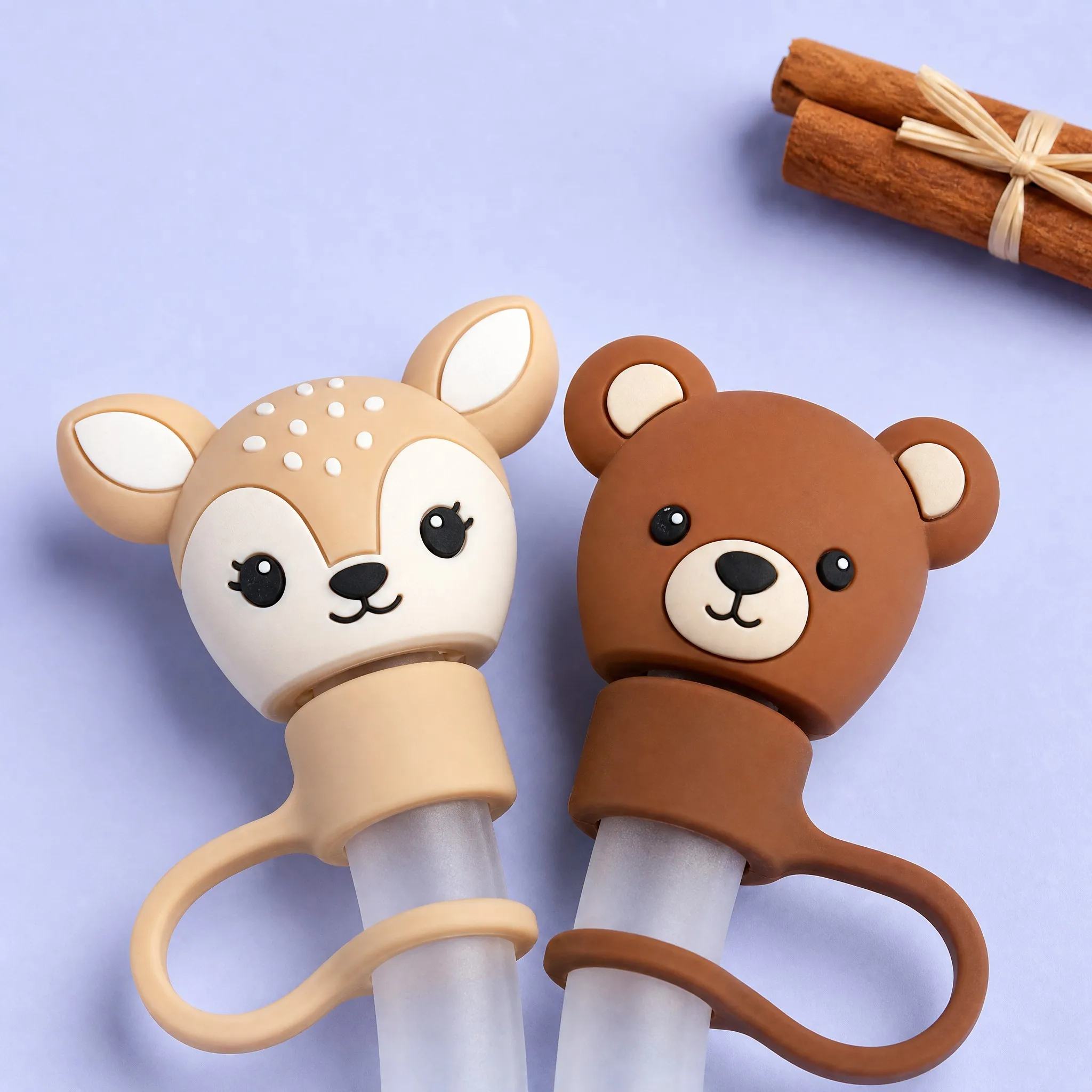 Baby Deer and Brown Bear Silicone Straw Caps Close-up with Cinnamon Sticks