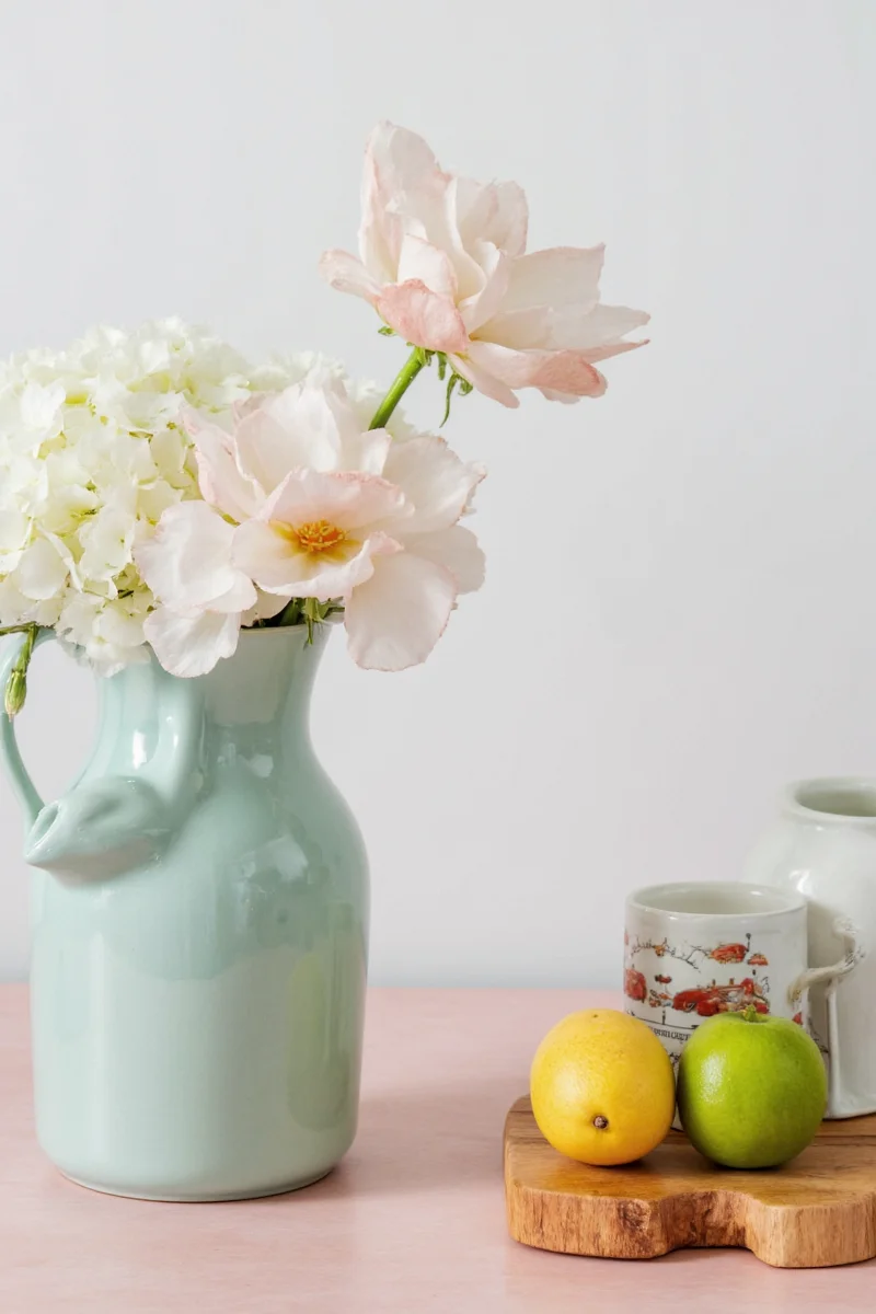 Five different bunny rabbit pitchers displayed on a white background, each with unique styles and colors.