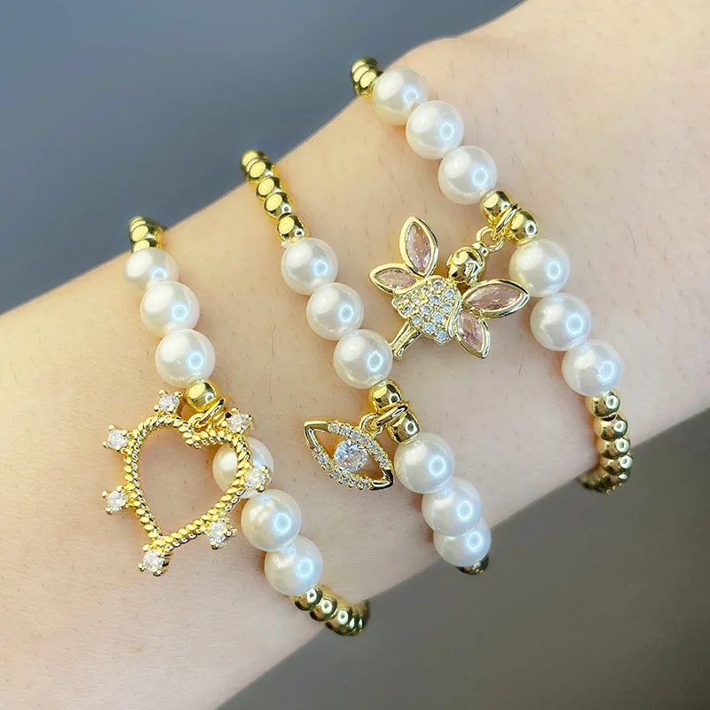 

New European And American Elastic Rope Hollow Heart Bangle Zircon Eye Gold Plated Pearl Bracelet