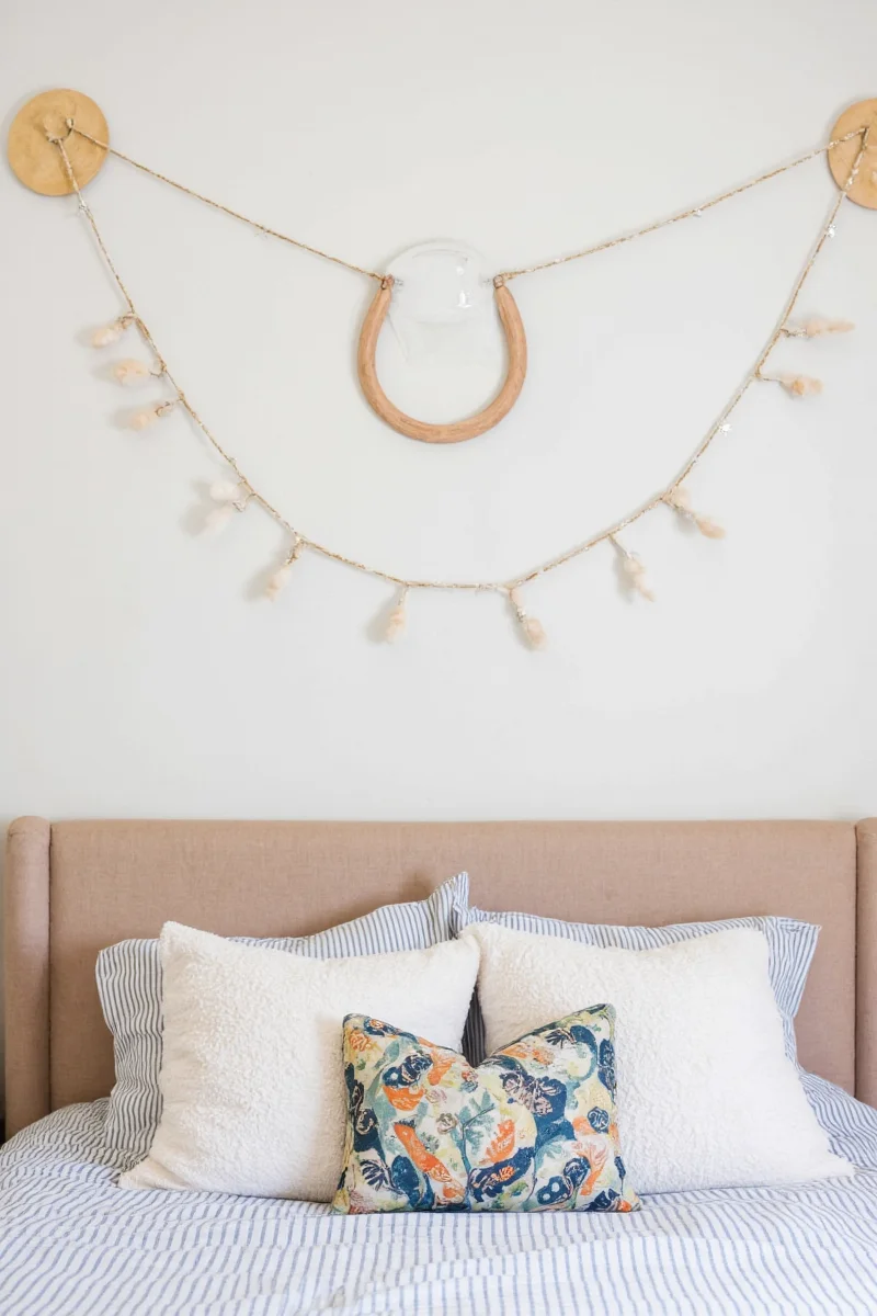 Wooden letters spelling name above bed