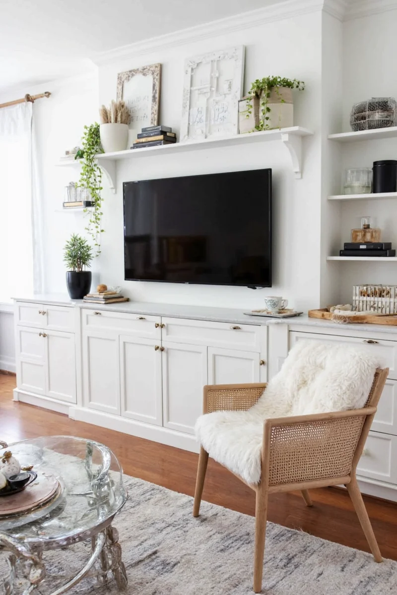 Gallery wall above TV with framed photos and childrens art
