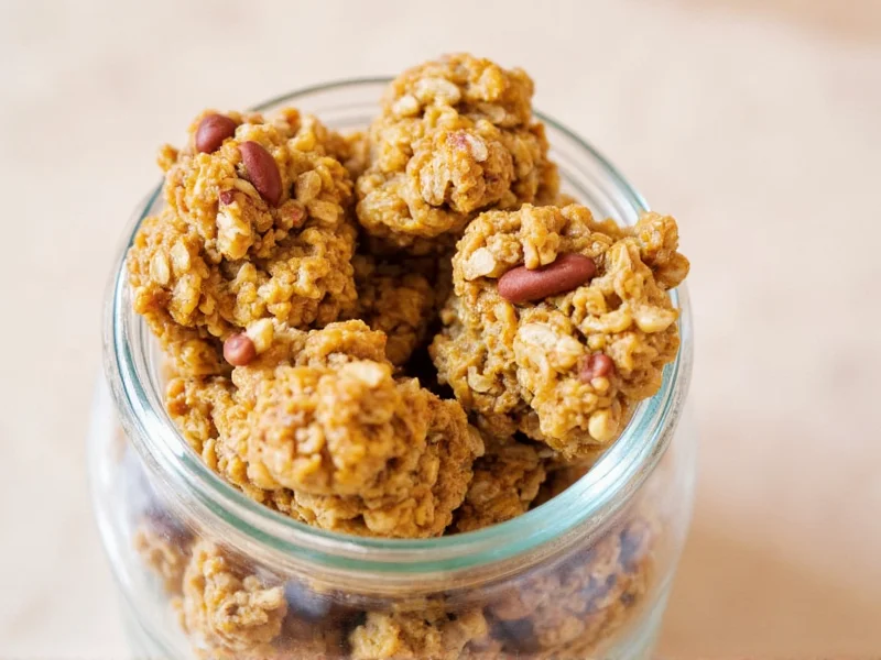 Golden homemade granola clusters in glass jar with oats and nuts