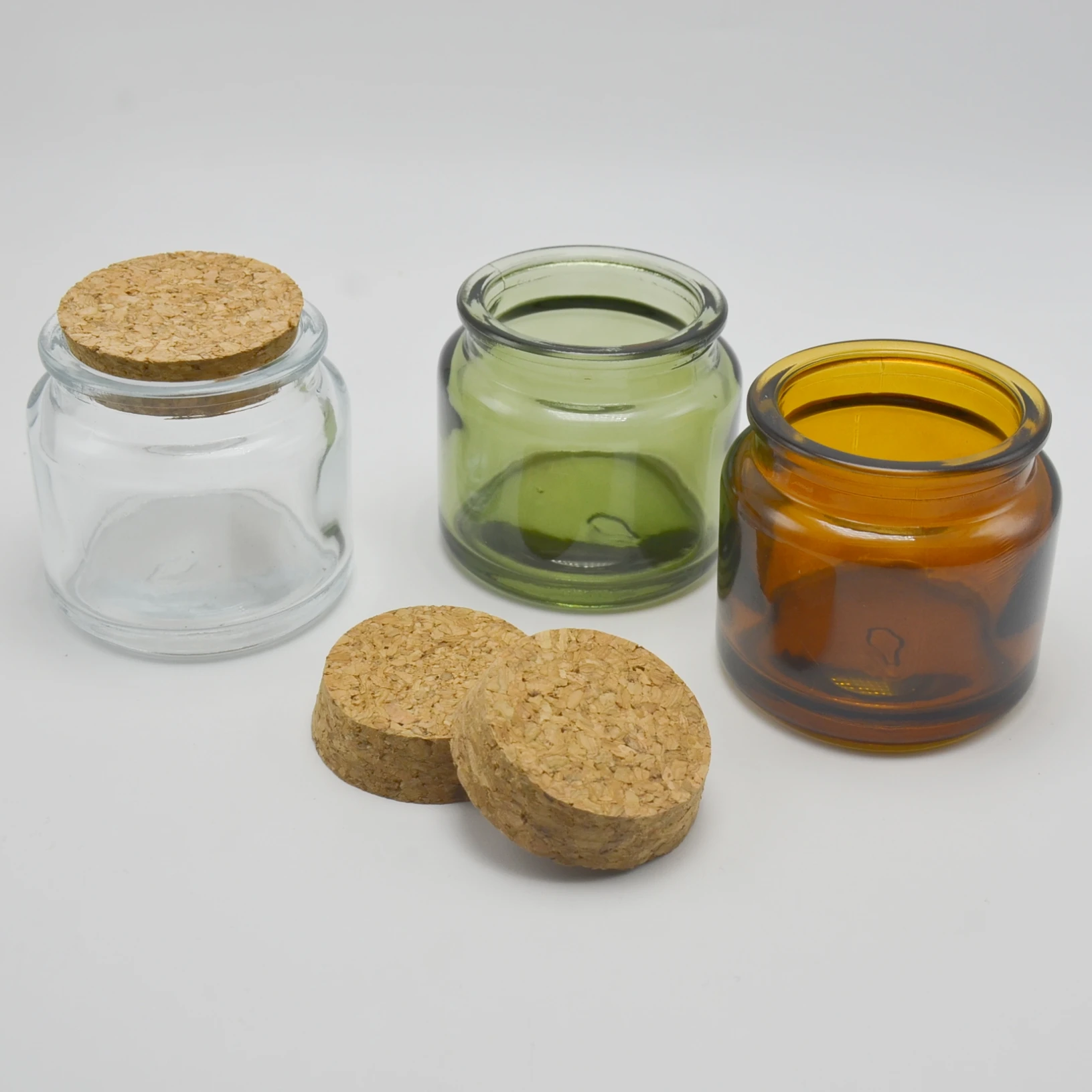 

New Arrival Empty 100ml Round Shape Amber Clear Green Glass Candle Jars with Cork and Wide Mouth
