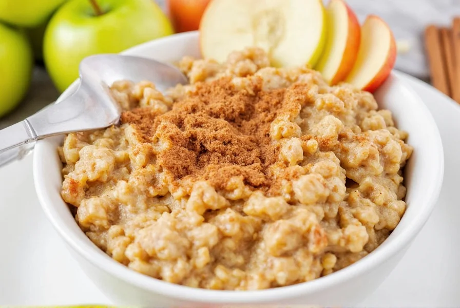 Finished bowl of cinnamon apple oatmeal with fresh apple slices and cinnamon sprinkle on wooden table
