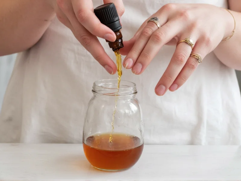 Hand pouring essential oils into linen spray mixture