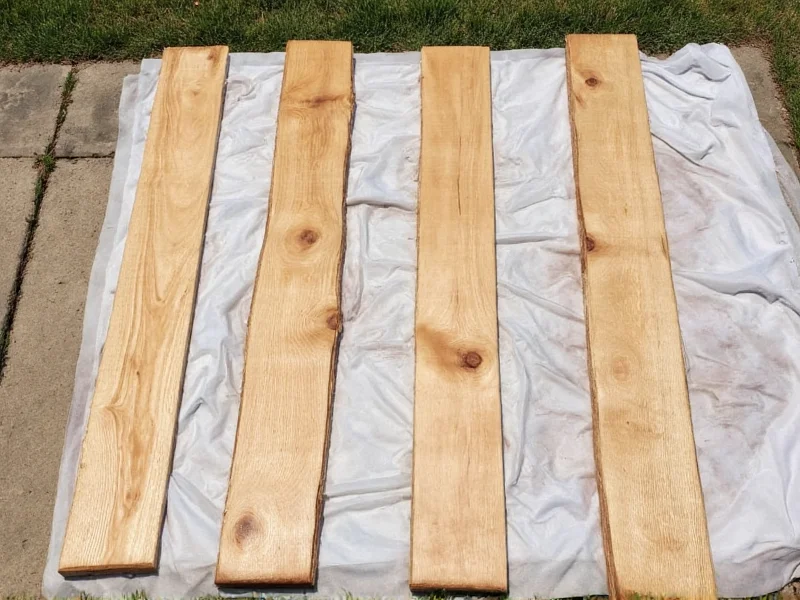Reclaimed wood pieces laid out for diy hall tree project