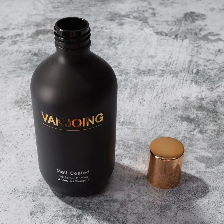 Luxury Matt Black Coating Bottle With Gold Shining Logo And Golden Disc