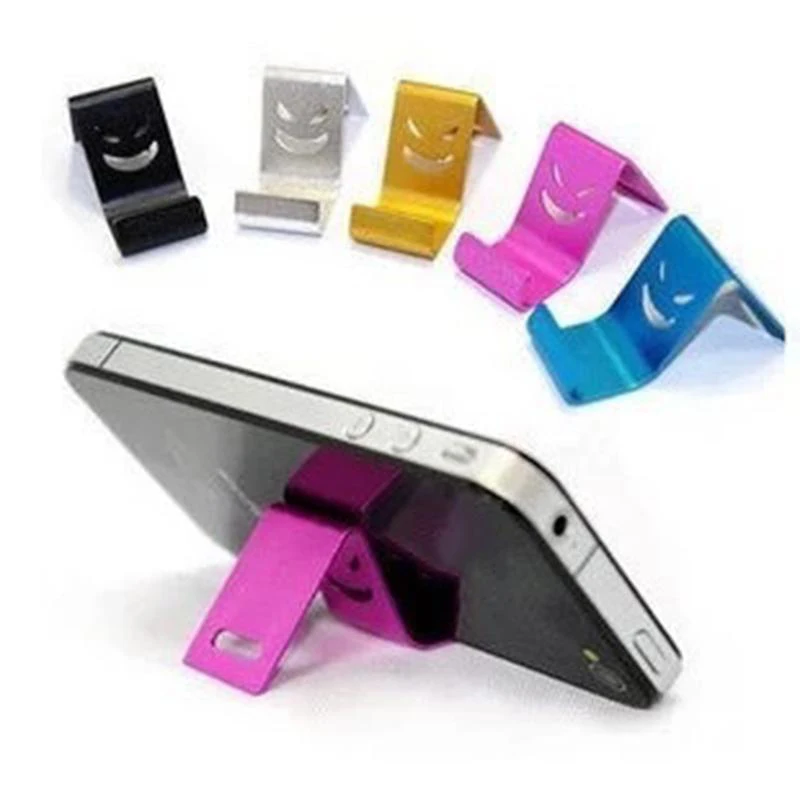 

Wholesale-Universal Phone Mini Aluminum Stand Holder For Tablet Metal Alloy little Smile Devil mount Random Color for iPhone MP4, As the picture shown, random