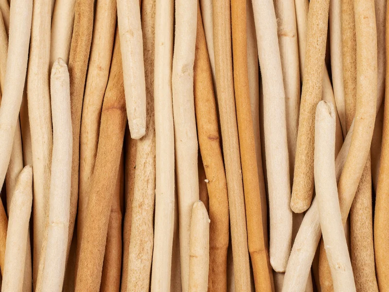 Hand-sorted wooden craft sticks by thickness