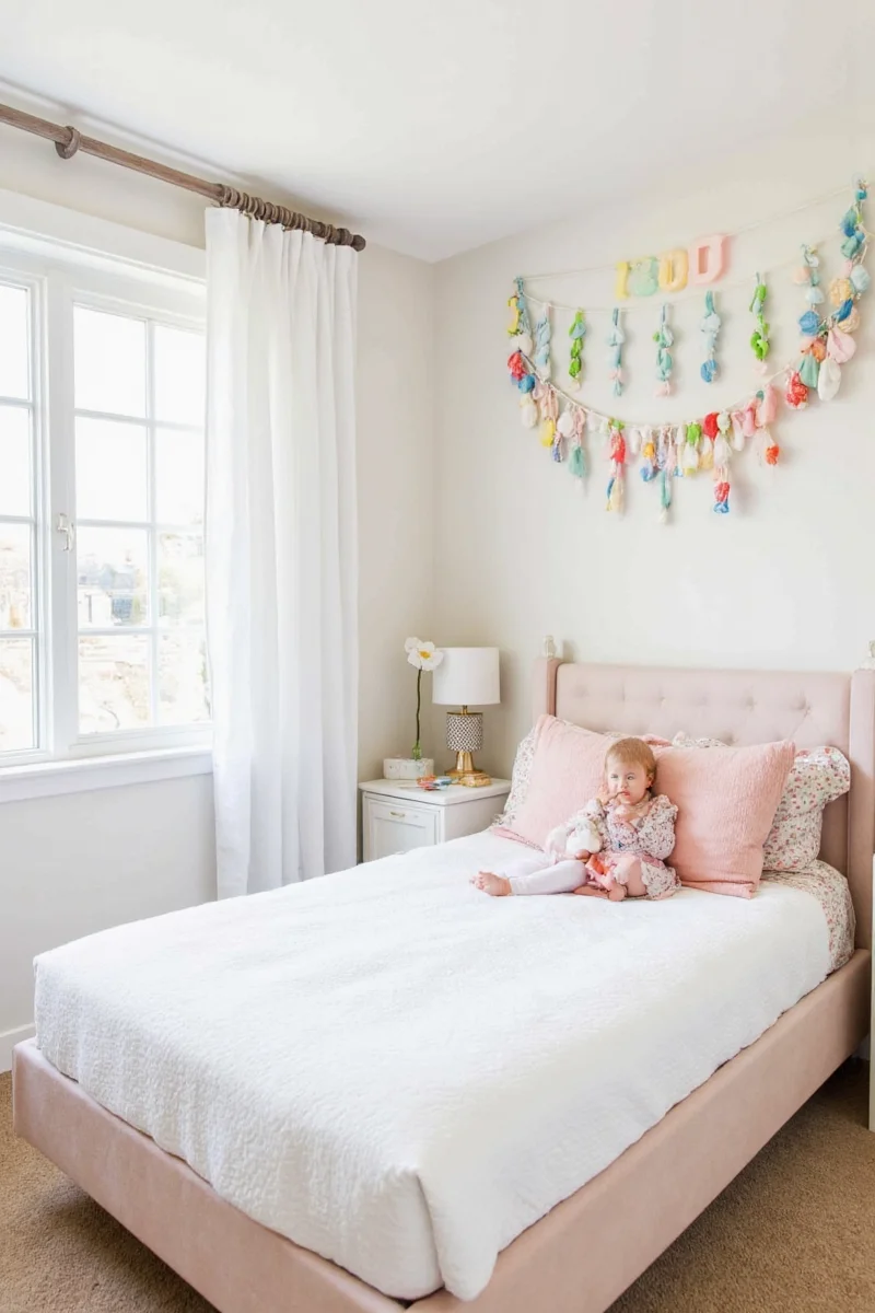 Colorful felt letter banners above bed