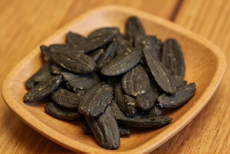 Traditional preparation of black ginger tea showing dried rhizome pieces steeping in water
