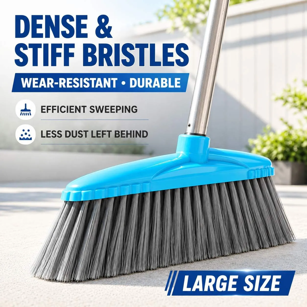 Large-size sweeping broom with dense stiff bristles, blue plastic head and metal handle, shown on a concrete patio