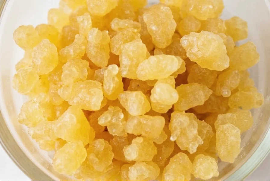 Person preparing ginger tea using crystals in a mug with lemon slice