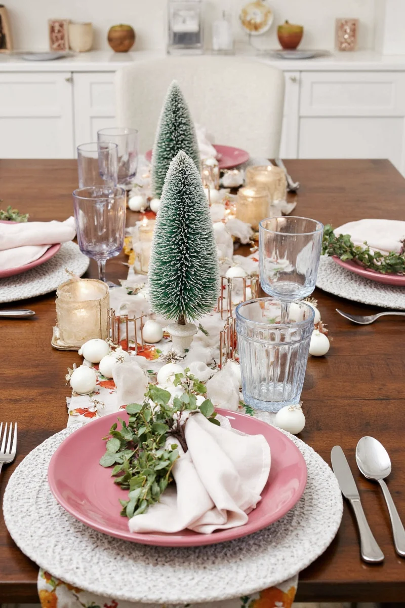 Natural Christmas table decor with greenery and pinecones